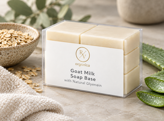 RV Organica Goat Milk Soap Base on stone with a bowl of oats, a cut aloe vera leaf and a soft cotton towel for dry, itchy skin