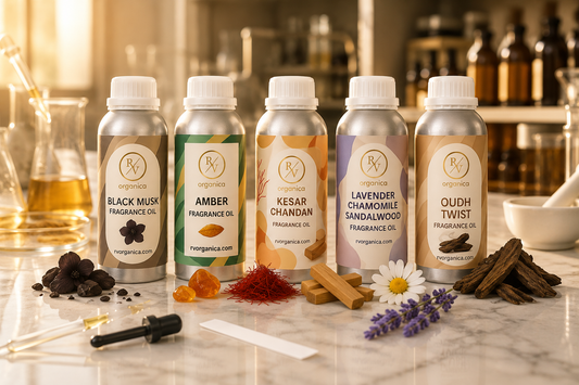 Five fragrance oil bottles including Black Musk, Amber, Kesar Chandan, Lavender Chamomile Sandalwood, and Oudh Twist arranged in a premium fragrance laboratory setting