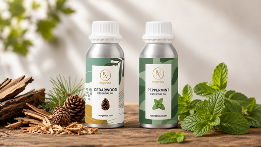 Cedarwood and Peppermint Essential Oil aluminum bottles on a rustic wooden surface with cedar wood shavings, pine cones, and fresh mint leaves, natural light product photography by RV Organica.