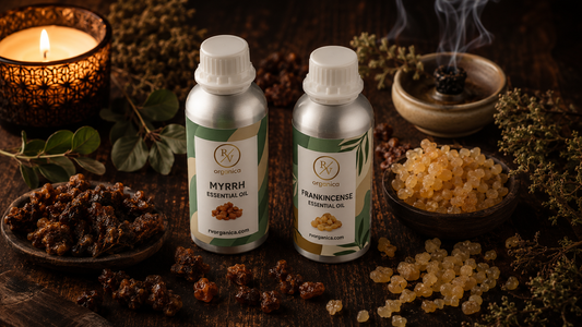 RV Organica Myrrh Essential Oil and Frankincense Essential Oil in silver aluminum bottles with natural resin on a dark wooden surface, luxury aromatherapy product photography.