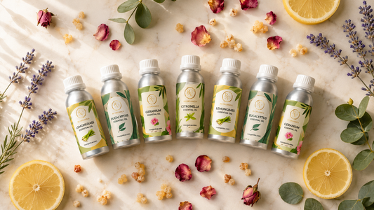 RV Organica essential oils collection — Lemongrass, Eucalyptus, Citronella and Geranium essential oils in aluminium bottles arranged on marble with rose petals, lemon slices and lavender sprigs