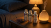 RV Organica Lavender, Rose, and Saffron essential oil bottles on a bedside table with a diffuser, natural sleep and relaxation aromatherapy