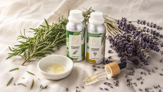 Premium lavender and rosemary essential oil bottles with botanical herbs on a light linen surface in a natural product photography setup.