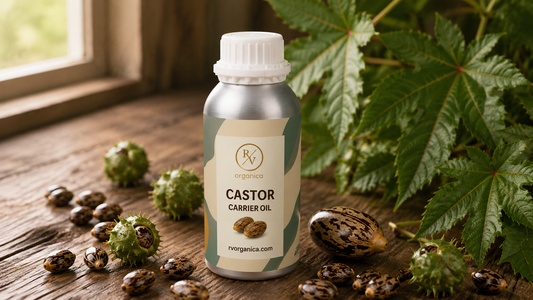 RV Organica cold pressed castor carrier oil with castor seeds and ricinus  plant leaves on wooden surface - natural scalp oil for hair growth
