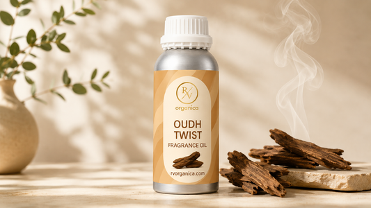 RV Organica Oudh Twist Fragrance Oil bottle with natural oud wood pieces and soft aromatic smoke on a beige background, luxury essential oil product photography