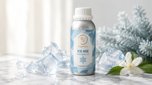 RV Organica Ice Age Fragrance Oil bottle on marble surface with ice cubes and white jasmine flowers