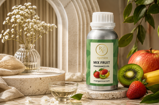“Premium Mix Fruit fragrance oil bottle with fresh kiwi, strawberry, banana and apple arranged in elegant luxury product photography setup on marble surface”