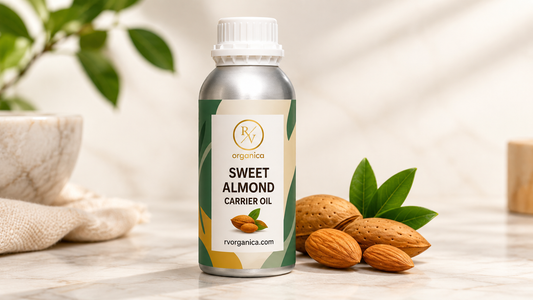 RV Organica sweet almond carrier oil bottle with almonds and green leaves on marble surface