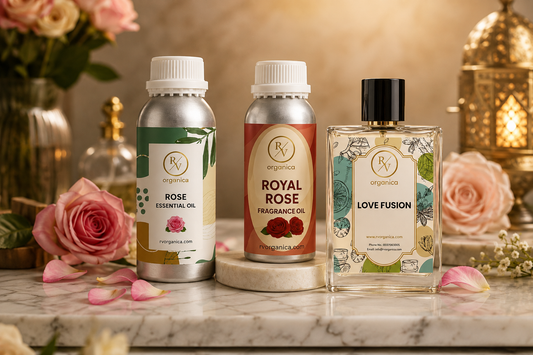 Premium RV Organica rose essential oil, royal rose fragrance oil, and Love Fusion perfume bottles arranged on marble with roses and petals