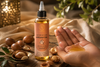 Premium Moroccan argan oil bottle with cold-pressed carrier oil, surrounded by argan nuts on a rustic wooden surface