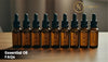 Essential Oil FAQs banner with amber glass dropper bottles – guide to aromatherapy oils and natural essential oil uses