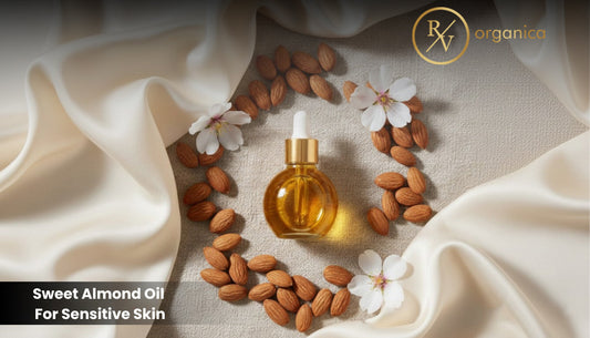 Sweet almond oil in glass dropper bottle surrounded by raw almonds and white blossoms on soft fabric background for natural skincare 