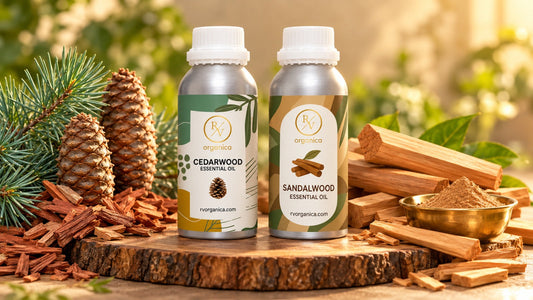 RV Organica cedarwood and sandalwood essential oil bottles side by side with cedar wood chips and sandalwood sticks