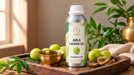 RV Organica Amla Carrier Oil aluminium bottle with fresh amla, dried amla slices and a brass bowl of oil on a rustic wooden tray.