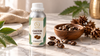 Castor carrier oil in an aluminum bottle with castor beans on a white marble surface, natural skincare product photography