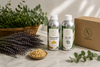 RV Organica frankincense and tea tree essential oil bottles with branded packaging, lavender and botanical ingredients on marble surface