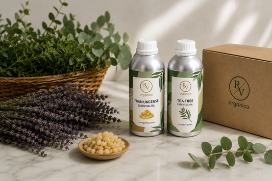 RV Organica frankincense and tea tree essential oil bottles with branded packaging, lavender and botanical ingredients on marble surface