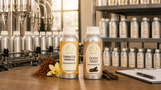 GMP fragrance oil manufacturing facility with RV Organica Tobacco Vanilla and Oudh Twist fragrance oil bottles on wooden table