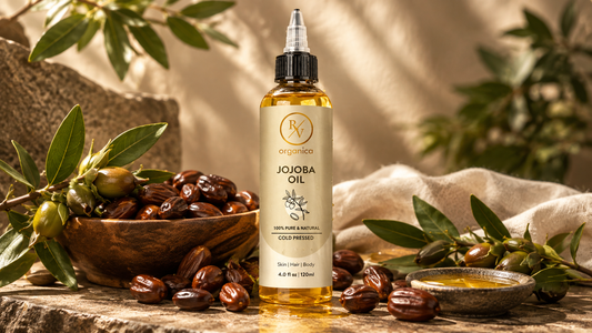Cold pressed jojoba oil in amber glass bottle with jojoba seeds on natural linen fabric