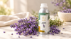 Lavender essential oil in RV Organica aluminum bottle with fresh lavender flowers on marble surface