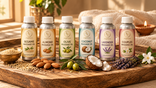 Aluminium bottle massage oil collection featuring sesame, almond, olive, coconut, lavender, and couples massage oils arranged with natural ingredients on a rustic wooden tray.