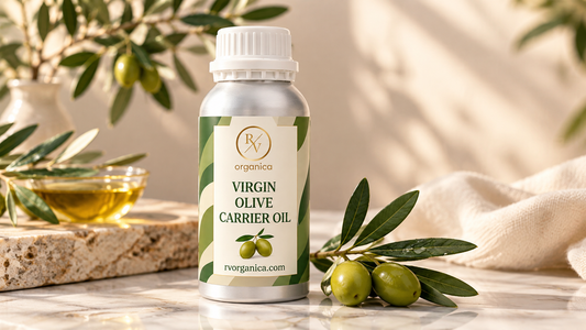 RV Organica virgin olive carrier oil bottle with fresh olive branches and olives on a premium marble surface