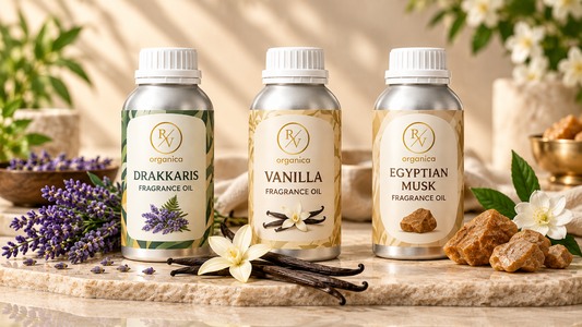 Three RV Organica fragrance oils including Drakkaris, Vanilla and Egyptian Musk in premium bottles with matching fragrance ingredients.