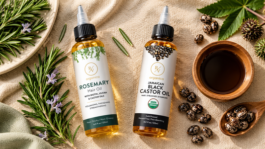 RV Organica rosemary hair oil and Jamaican black castor oil bottles with fresh rosemary, castor seeds, and natural botanical ingredients on beige linen