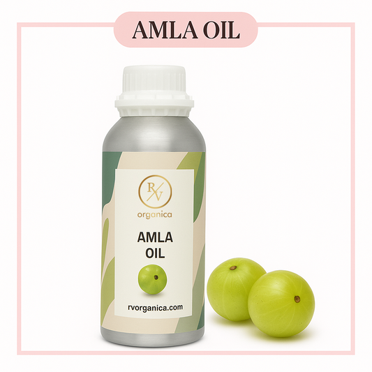 A bottle of Amla Oil with a white cap, alongside two amla fruits. The label on the bottle reads 'AMLA OIL' and has a subdomain 'rvorganica.
