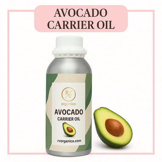 A bottle of avocado carrier oil with a white label, next to a cut avocado showing the seed and flesh.