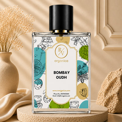 Bombay Oudh Premium Fragrance Oil by RV Organica in a clear glass bottle with a black cap, displayed on a beige stone pedestal with elegant botanical décor for luxury home fragrance and perfume making.
