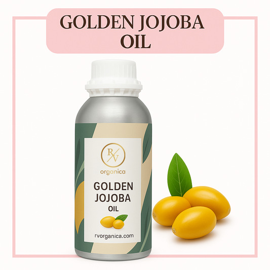 A bottle of Golden Jojoba Oil with the brand name RV Organica on it, accompanied by an image of golden jojoba seeds and a green leaf.