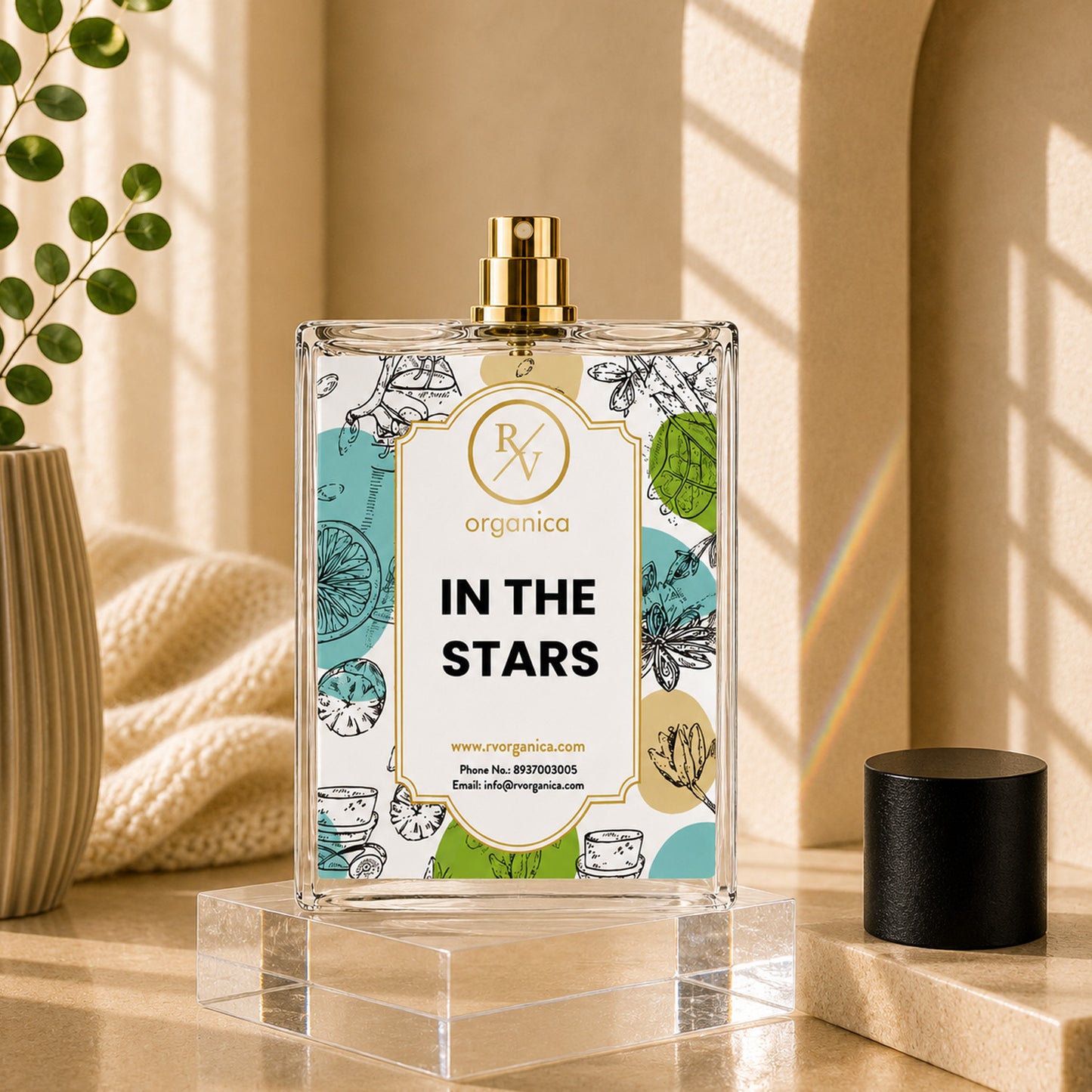 RV Organica In The Stars premium fragrance oil with open spray bottle displayed on a clear acrylic stand and elegant beige luxury background.