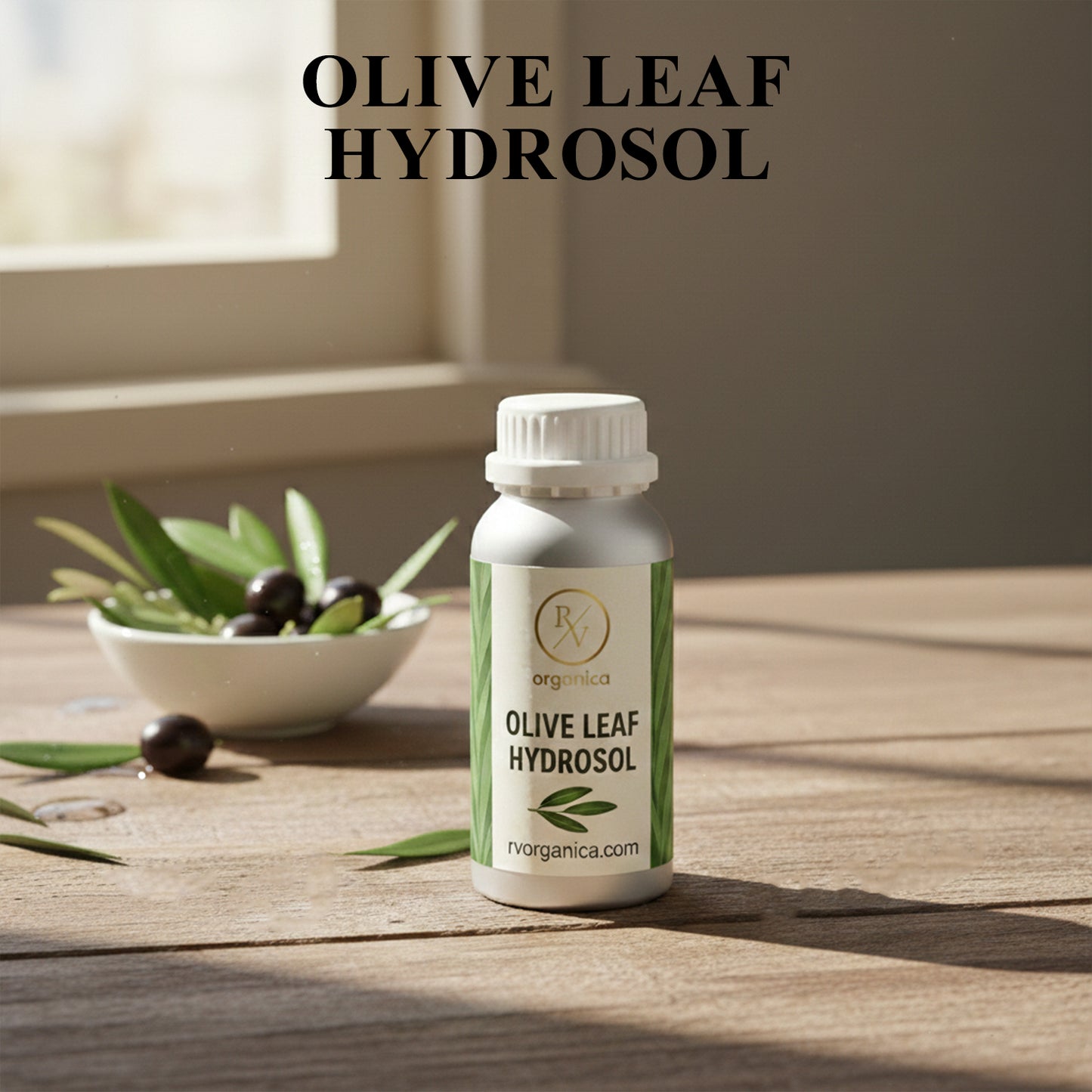 Organic Olive Leaf Hydrosol facial mist bottle with fresh olives and leaves, natural skin toner for hydration and glowing skin.