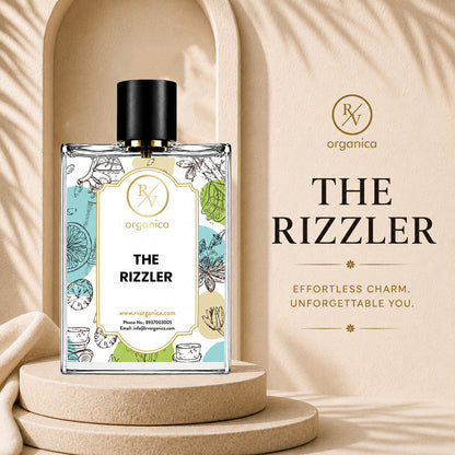 RV Organica The Rizzler Premium Fragrance Oil bottle displayed with product branding in an elegant beige setting