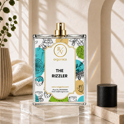 Front view of RV Organica The Rizzler fragrance oil bottle on a clear acrylic display stand
