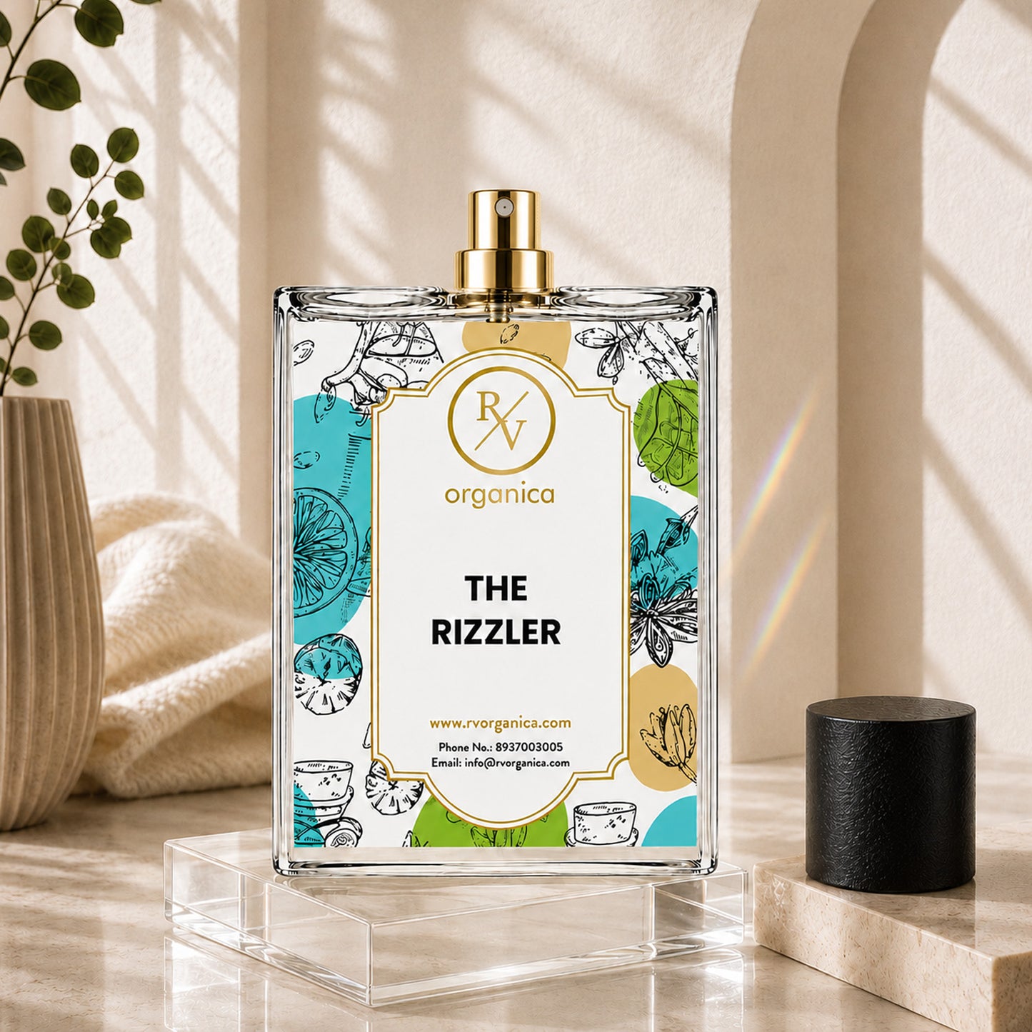 Front view of RV Organica The Rizzler fragrance oil bottle on a clear acrylic display stand