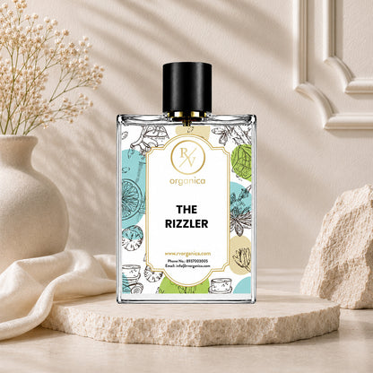 Front view of RV Organica The Rizzler fragrance oil bottle in a luxury lifestyle product display