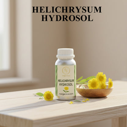 RV Organica Helichrysum Hydrosol natural floral water bottle displayed with fresh yellow helichrysum flowers for organic skincare routine