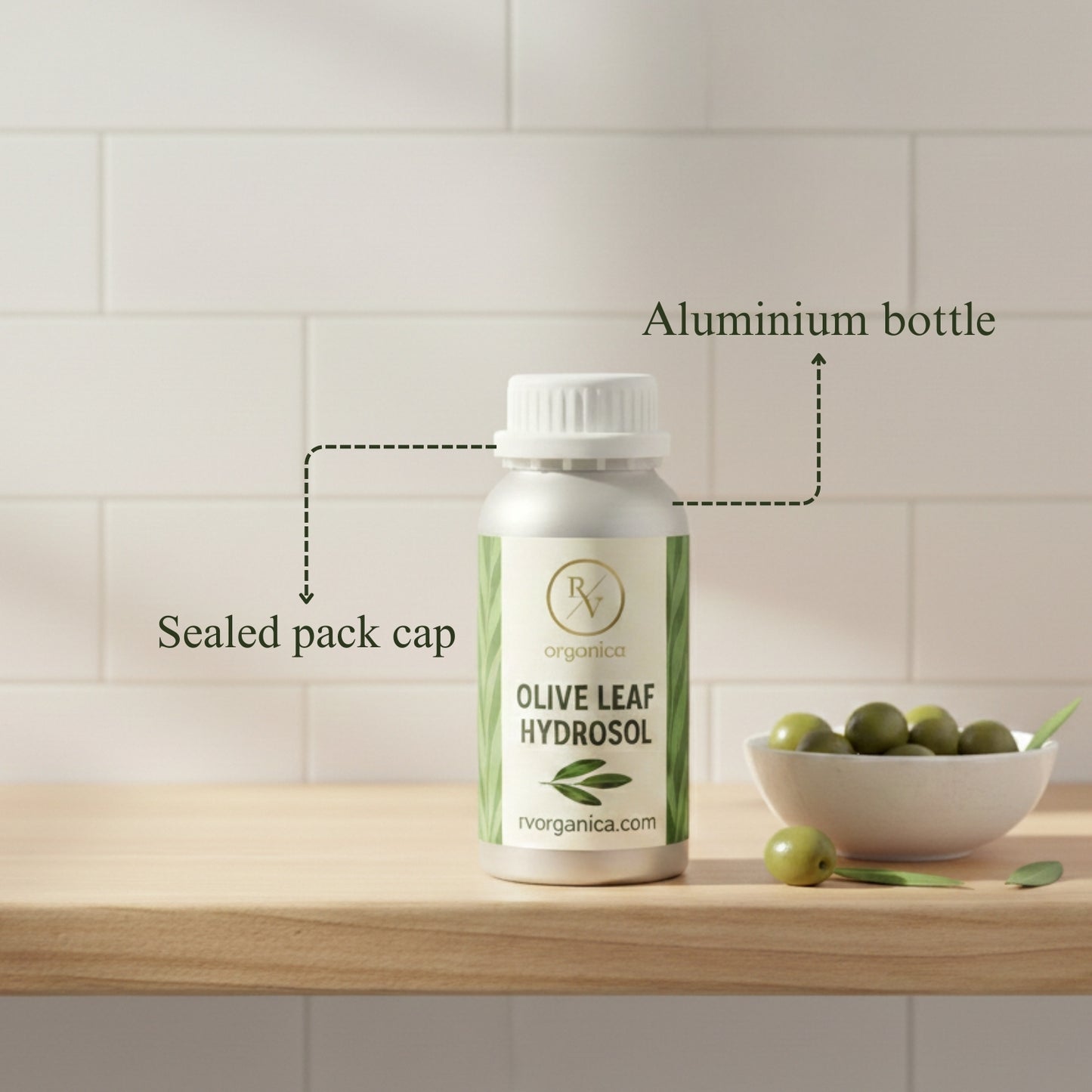 Olive Leaf Hydrosol in aluminium bottle with sealed cap packaging, organic natural skincare toner on wooden table with olives.