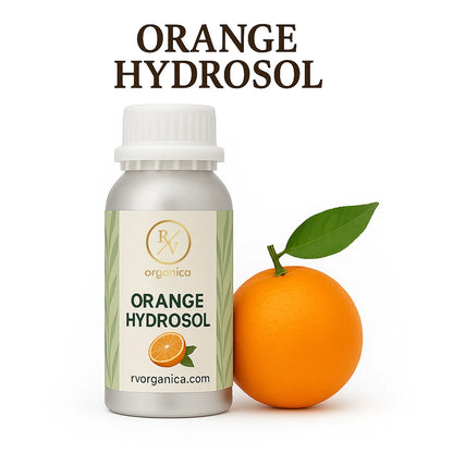 A bottle of Orange Hydrosol with a white cap, labeled with the brand RV Organica, alongside a fresh orange and a green leaf.