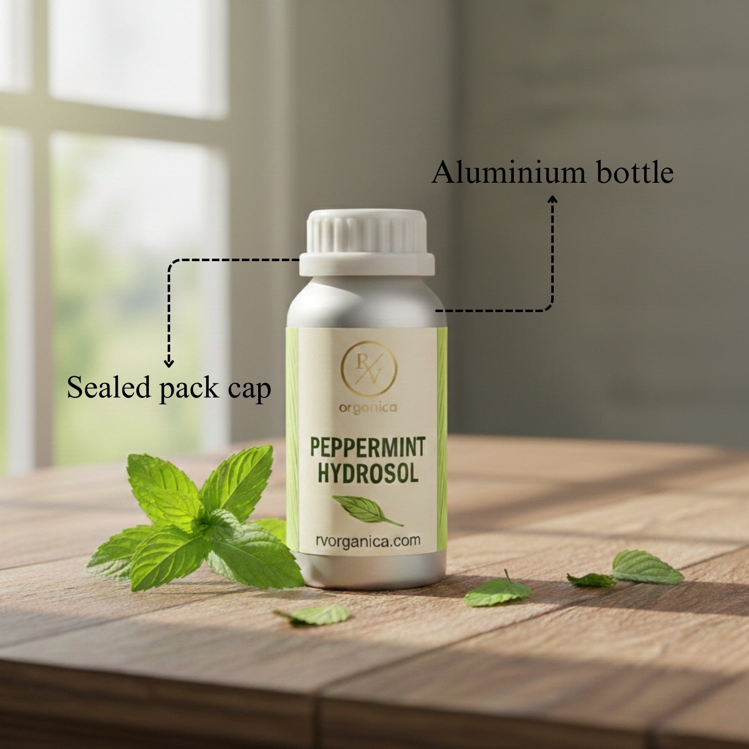 Peppermint Hydrosol in aluminium bottle with sealed cap packaging, natural organic skincare toner with fresh mint leaves on wooden table.