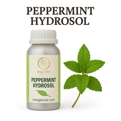 A bottle of RV Organica Peppermint Hydrosol with a fresh peppermint leaf next to it.