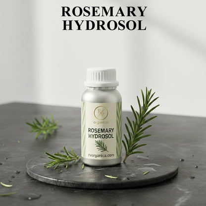Organic Rosemary Hydrosol facial mist bottle with fresh rosemary leaves, natural herbal skin toner for hydration and daily skincare routine.